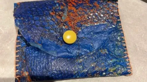 A small blue coin purse made of soft plastic