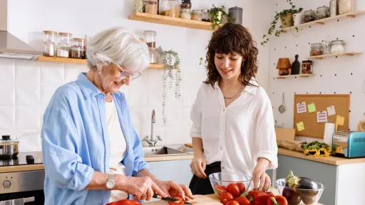 Two women preparing food in the kitchen
