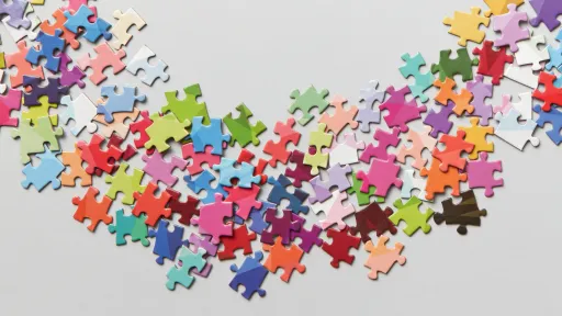Colourful puzzle pieces are scattered on a grey background