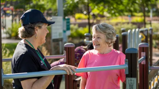 two people talking over exercise equipment