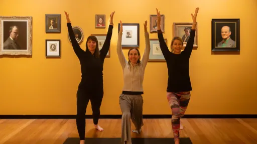 three women with arms raised in gallery