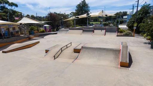 A skate park with ramps, rails and ledges.