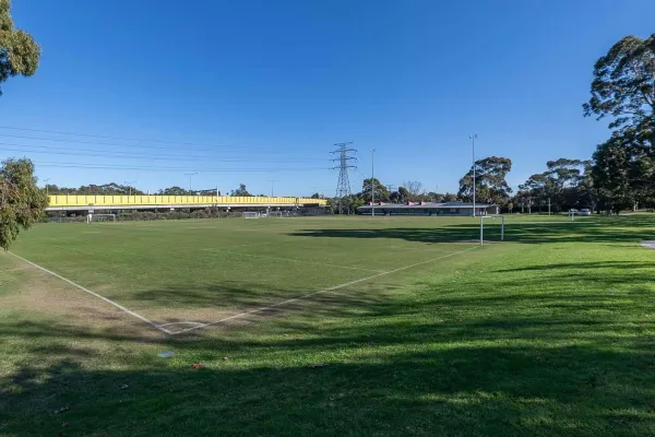 A rectangular sportsground with soccer goal posts