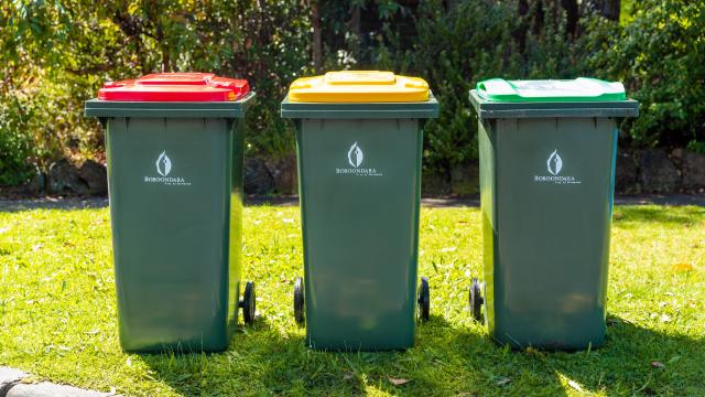 a set of 3 boroondara waste bins sitting on a nature strip