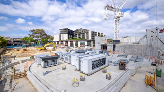A construction zone with a large cement slab and prefab buildings