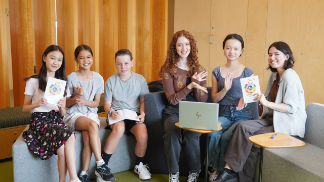 Six Literary Awards winners sit and show off their awards.