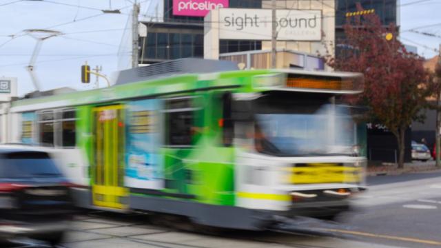 Blurred image of tram and cars at Camberwell Junction.