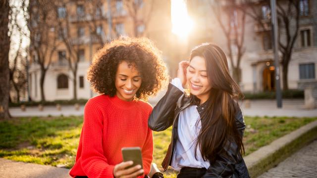 Two people looking at mobile phone