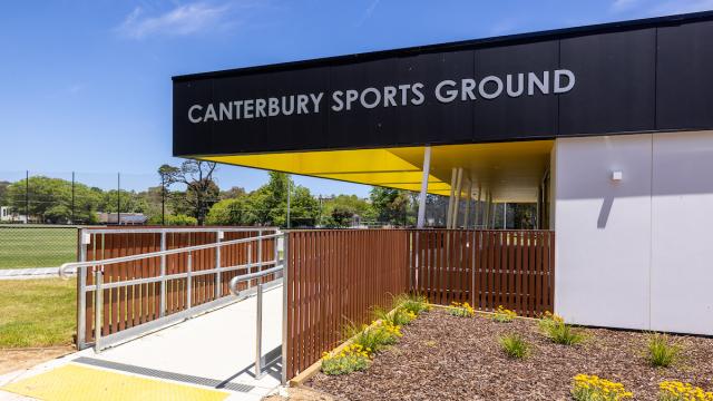 the exterior of Canterbury Sports Ground pavilion with signage and a ramp entry