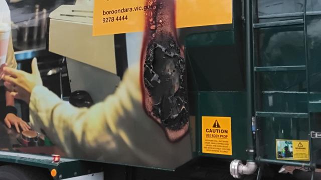 A hole burnt into the side of a recycling truck