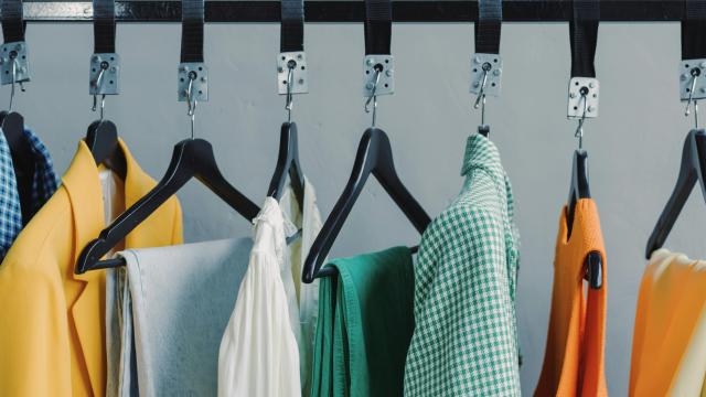 Assorted clothes hanging on black steel rack