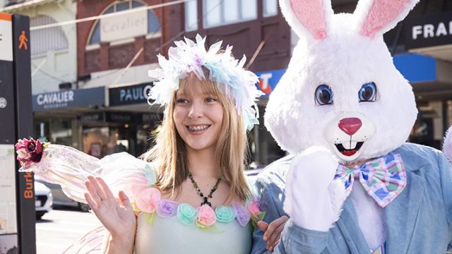 The Easter Bunny and a fairy friend standing together and waving