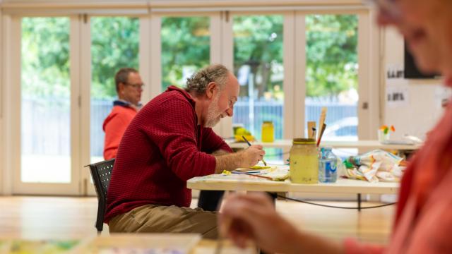 A man doing a craft activity at a community centre