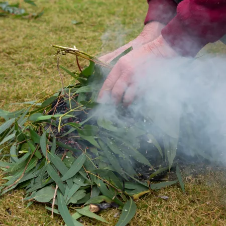 A person carrying out a traditional smoking ceremony