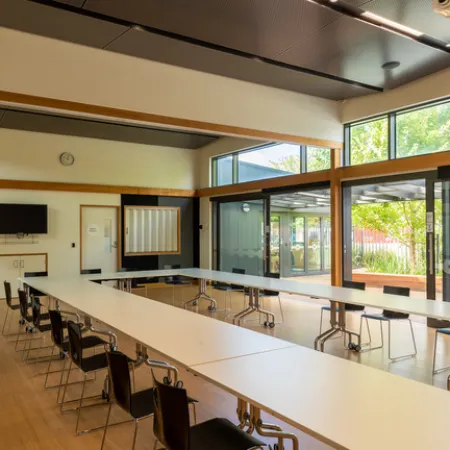 A large U-shaped table with chairs in a meeting room