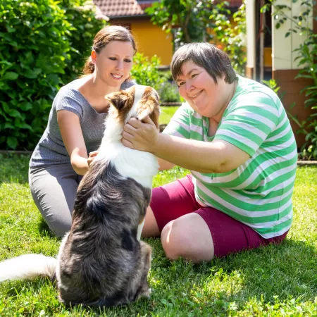 Two people outside with a dog