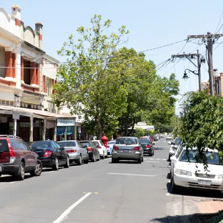Cars parked on both sides of a suburban shopping strip